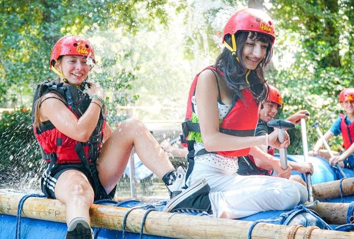 Teens laughing on their raft