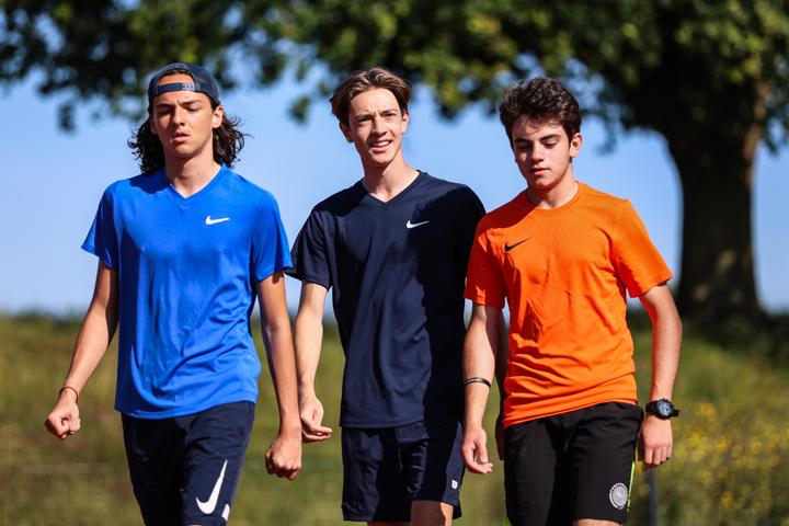 Three teenage campers walking across the grounds together