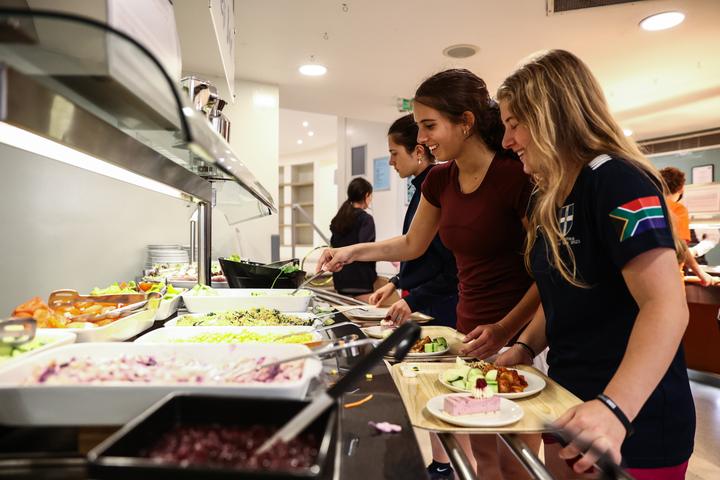 Campers choosing food at the dining-hall buffet