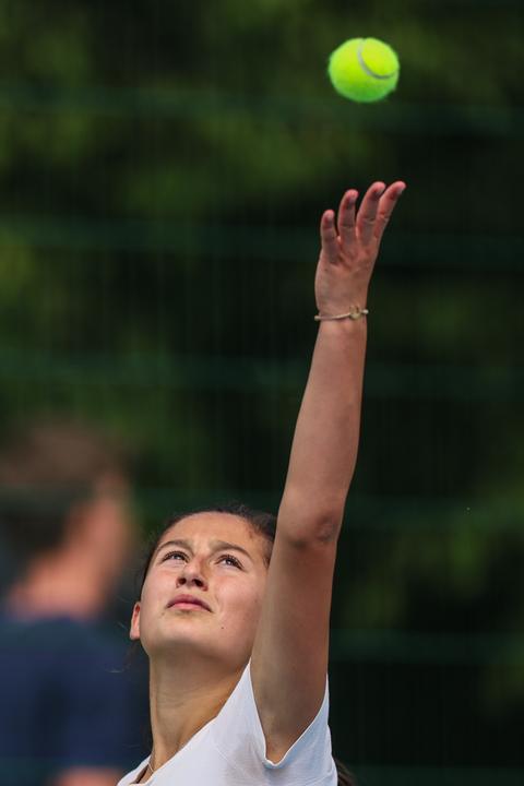 A player tossing the ball for a serve