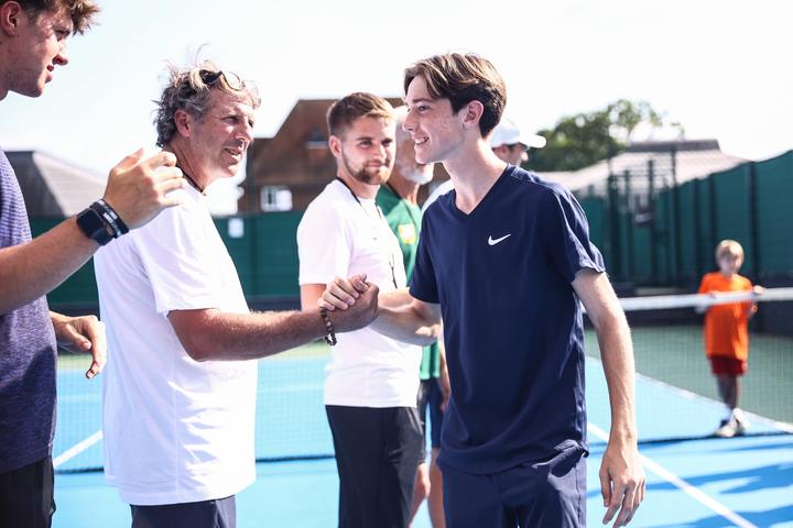 Coaches talking with an older player courtside