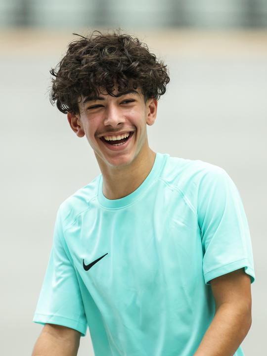 A smiling basketball camper in Nike kit