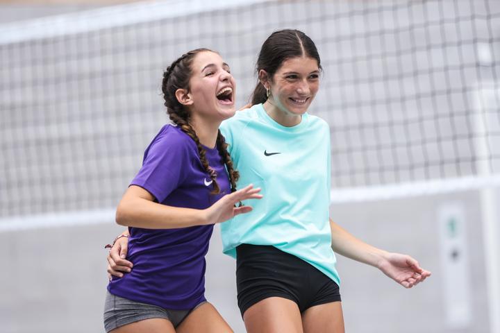Two players laughing together on court