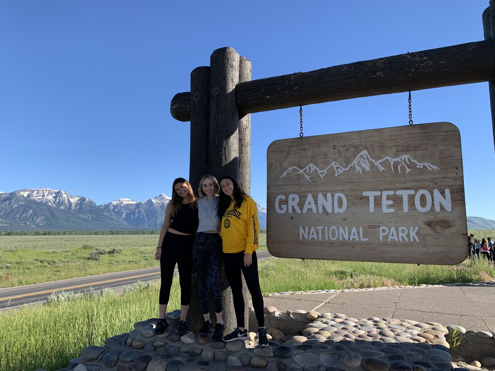 Three girls at the Grand Teton National Park sign