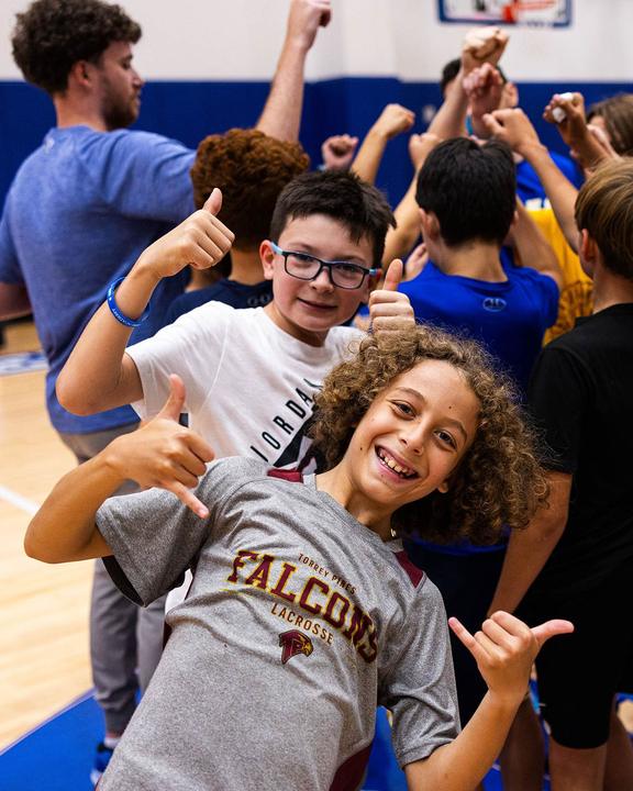 Boys giving thumbs up during a break in basketball training