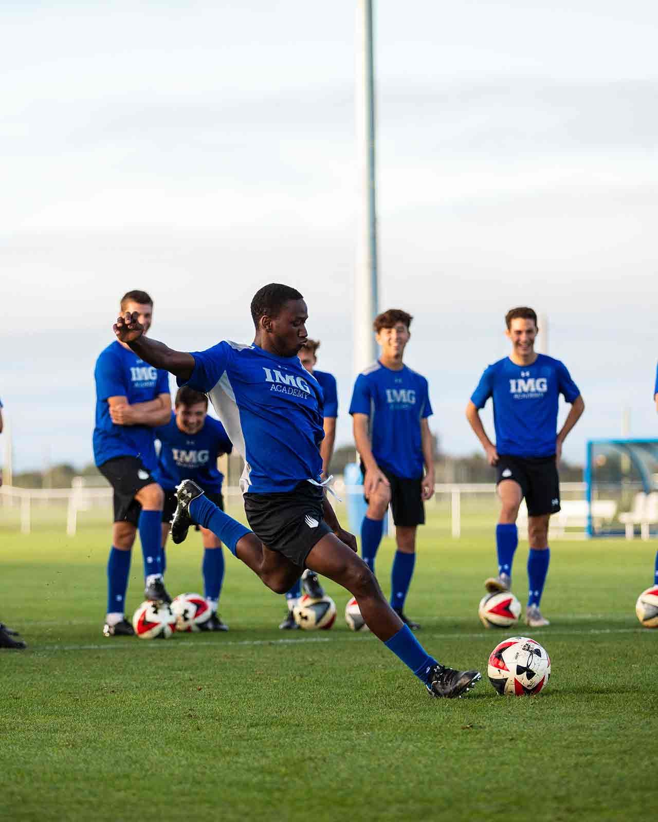 Boys taking shots in turn during a finishing drill