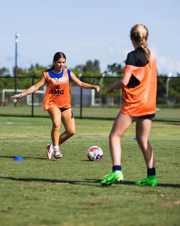 Girls in training bibs working on passing