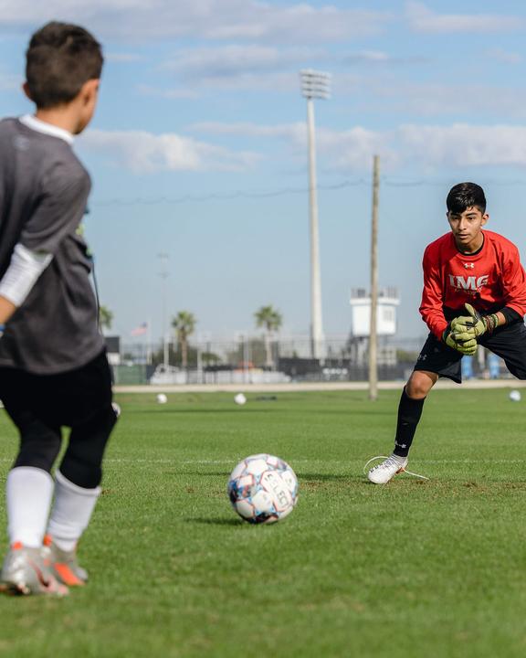 A young goalkeeper ready to save a shot