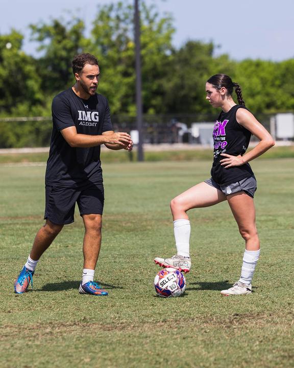 A coach giving a girl feedback during a training session