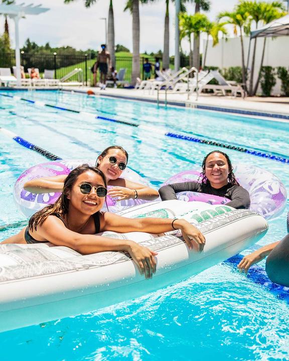 Girls relaxing on floats in the outdoor pool