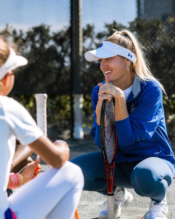 A coach chatting with players during a break