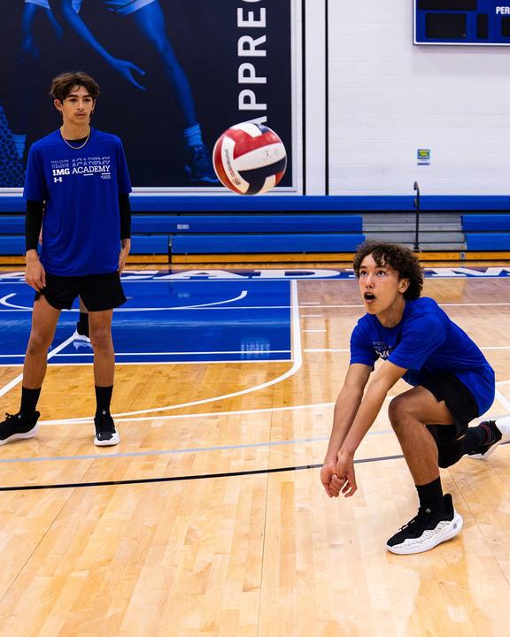 A boy passing the ball in a defensive drill