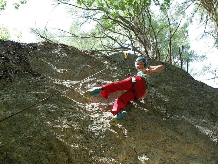 Camper rock climbing on a granite outcrop