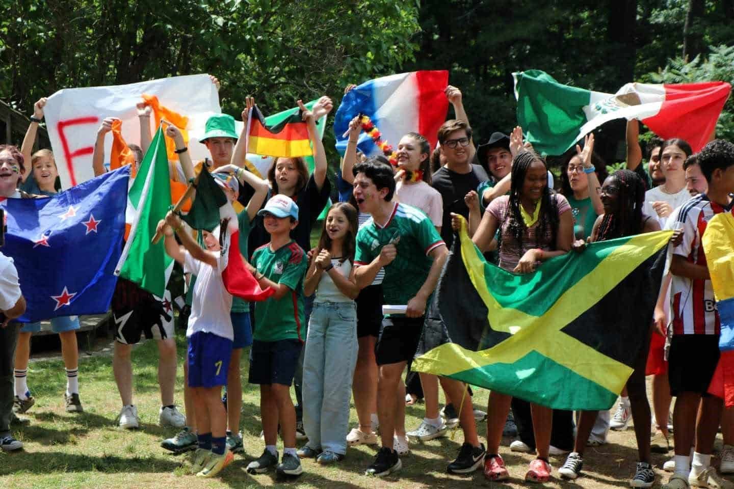 Campers from many countries cheering with their national flags