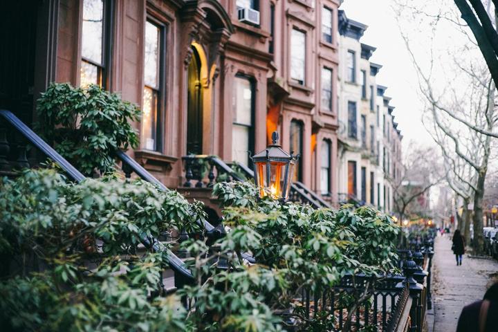 A tree-lined street of brownstones in Brooklyn