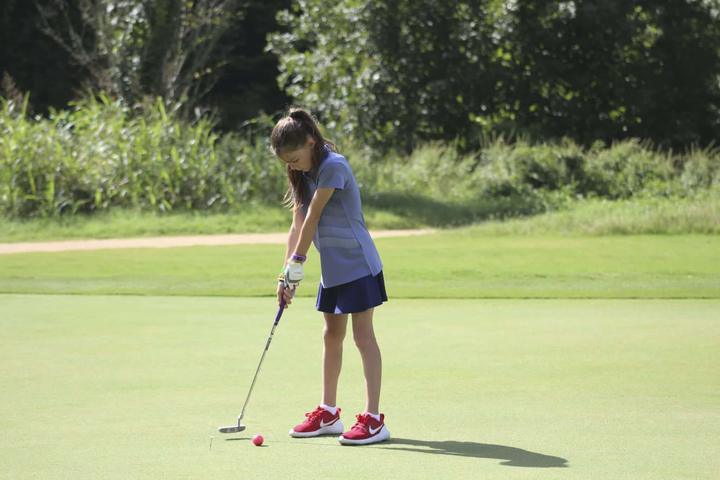 Camper putting on the golf green