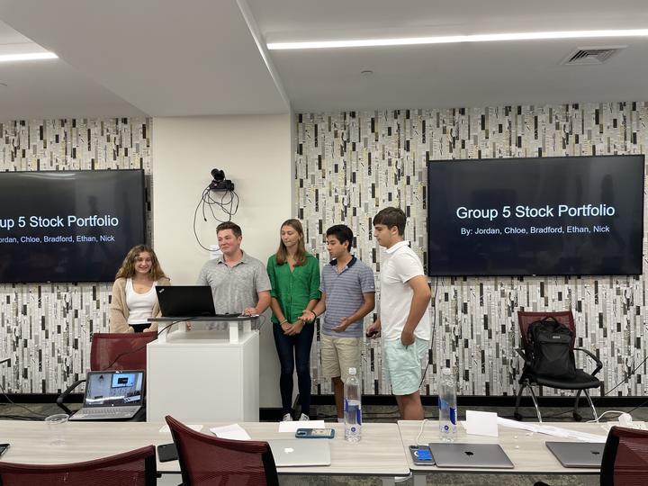 A team presenting their stock portfolio